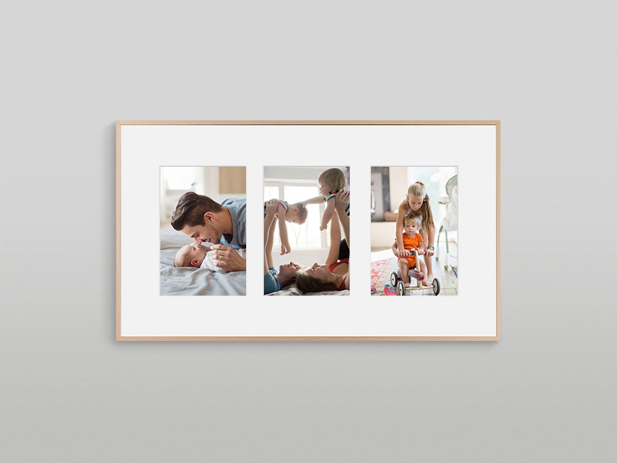 The Frame is hanging on a wall displaying 3 different types of pictures with a white matte background. LS03BBUXXH